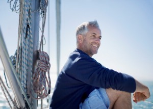 Man sitting on deck of boat