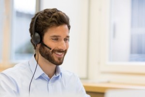 Happy Businessman in the office on the phone, headset, Skype